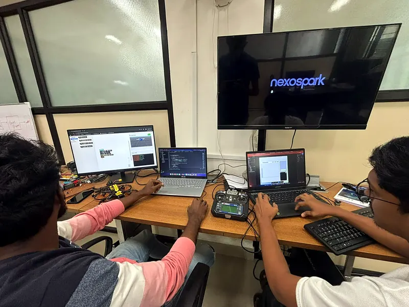 Engineers at the lab desks with a flight simulator and transmitter