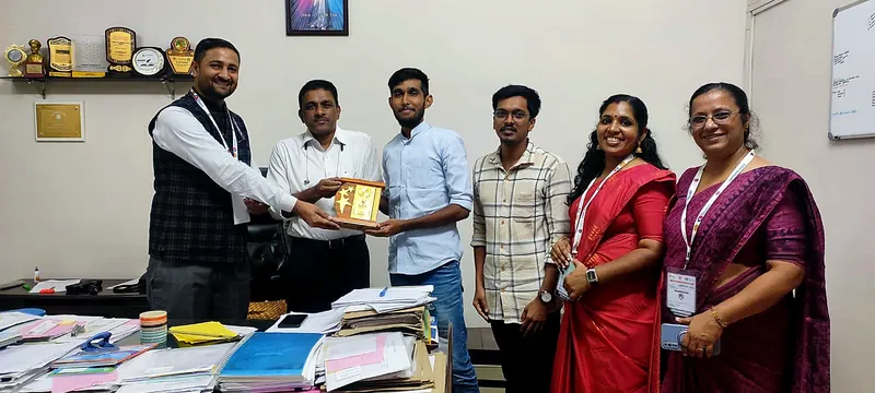 Aswin P Nair receiving a memento