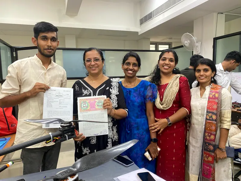 The Nexospark team and faculty members with signed MoU documents and a Nexospark drone in the lab