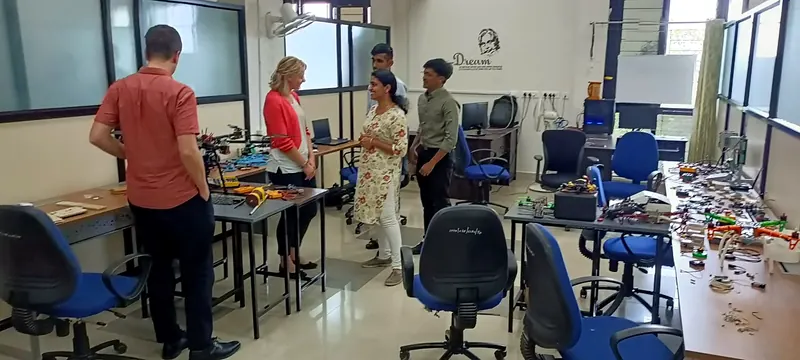 Visitors and the team among the drone builds in the lab